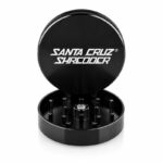 Santa Cruz Shredder black 2-piece grinder with open lid and visible teeth.