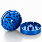 Blue Santa Cruz Shredder grinder opened to show the sharp internal teeth.
