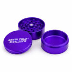 Santa Cruz Shredder purple 3-piece herb grinder disassembled on a white background.