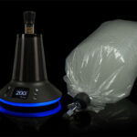 Arizer XQ2 desktop vaporizer with balloon bag on a black background