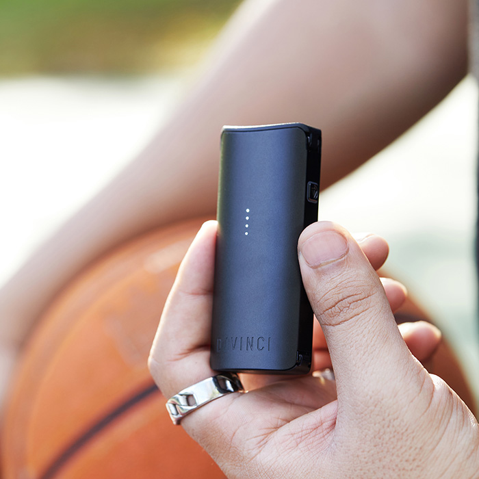 DaVinci MIQRO-C Vaporizer in blue being held outdoors.