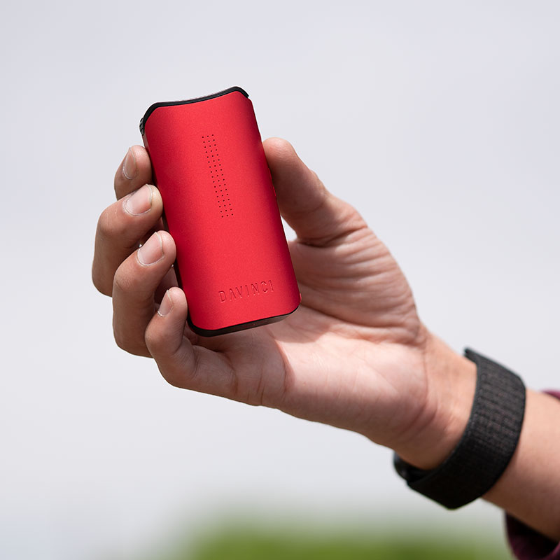 Red DaVinci IQC Vaporizer held in hand