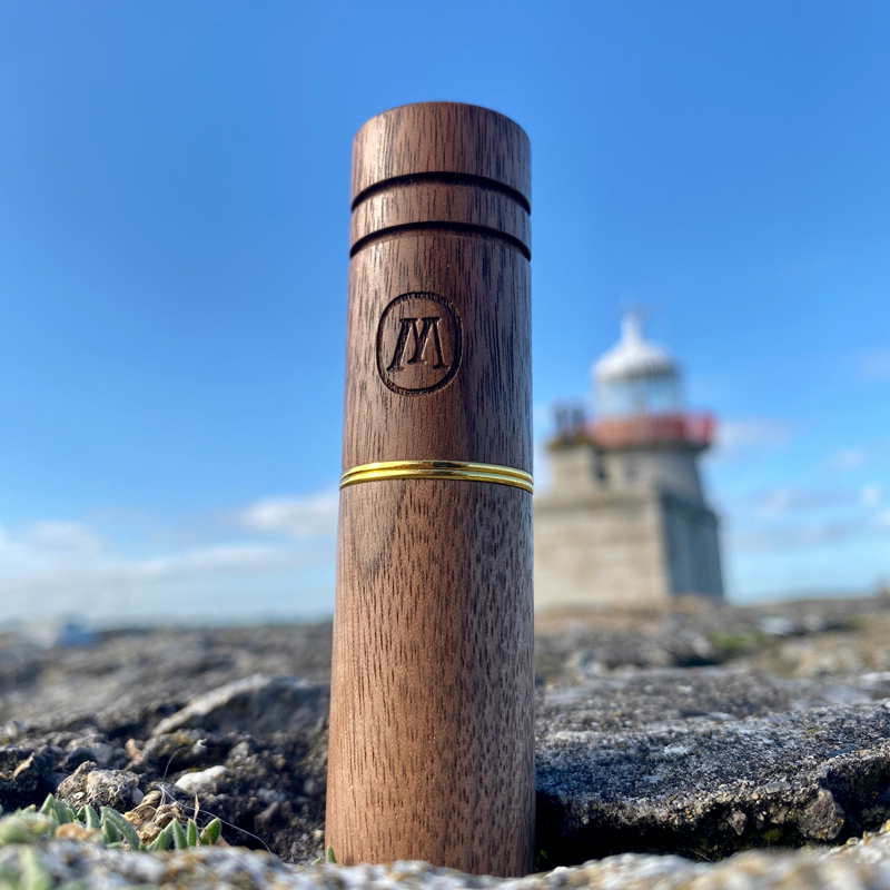 Marley holder with a lighthouse and coast behind it