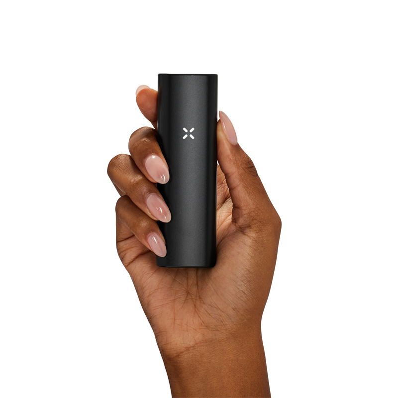 PAX Plus black dry herb vape held in a hand