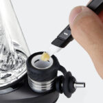 Close-up of Puffco Peak Pro 3DXL chamber being loaded with concentrate using a dab tool