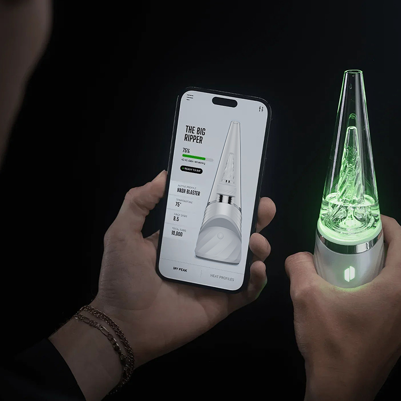 Puffco Peak Pro connected to smartphone app with green LED lighting