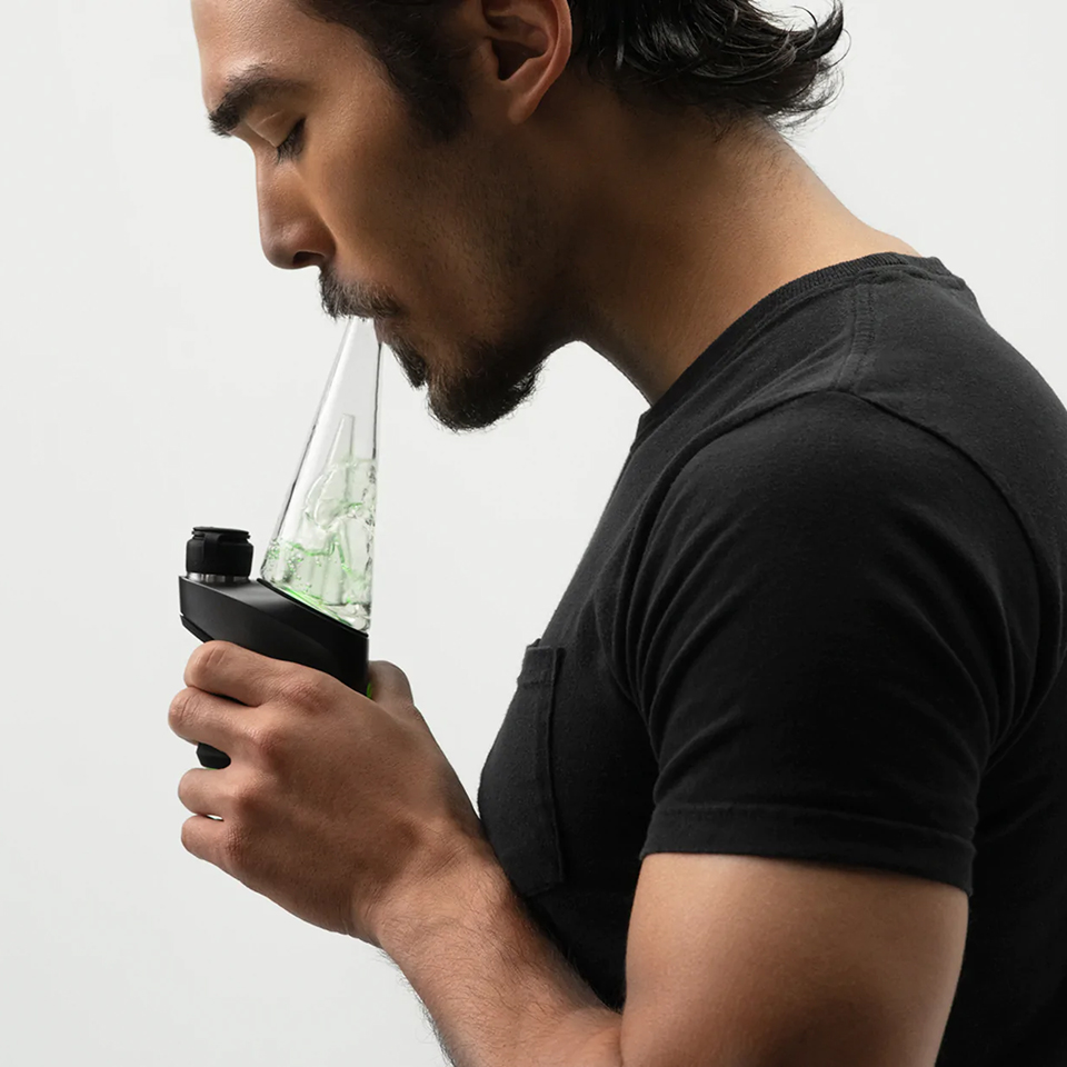 Person using Puffco Peak Pro concentrate vaporizer