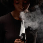 Person using Puffco Peak Pro concentrate vaporizer