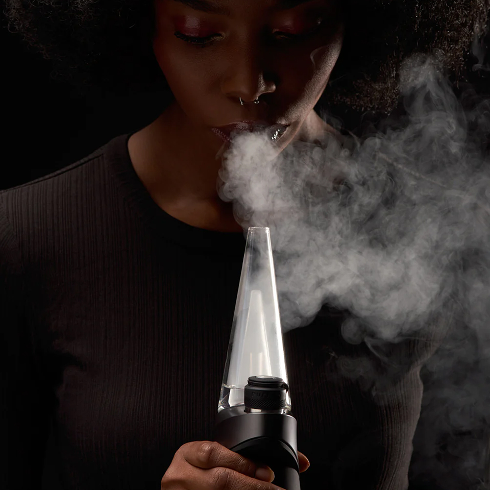 Person using Puffco Peak Pro concentrate vaporizer