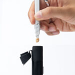 Close-up of the Puffco Pivot chamber being loaded with concentrate using a Puffco Hot Knife tool.