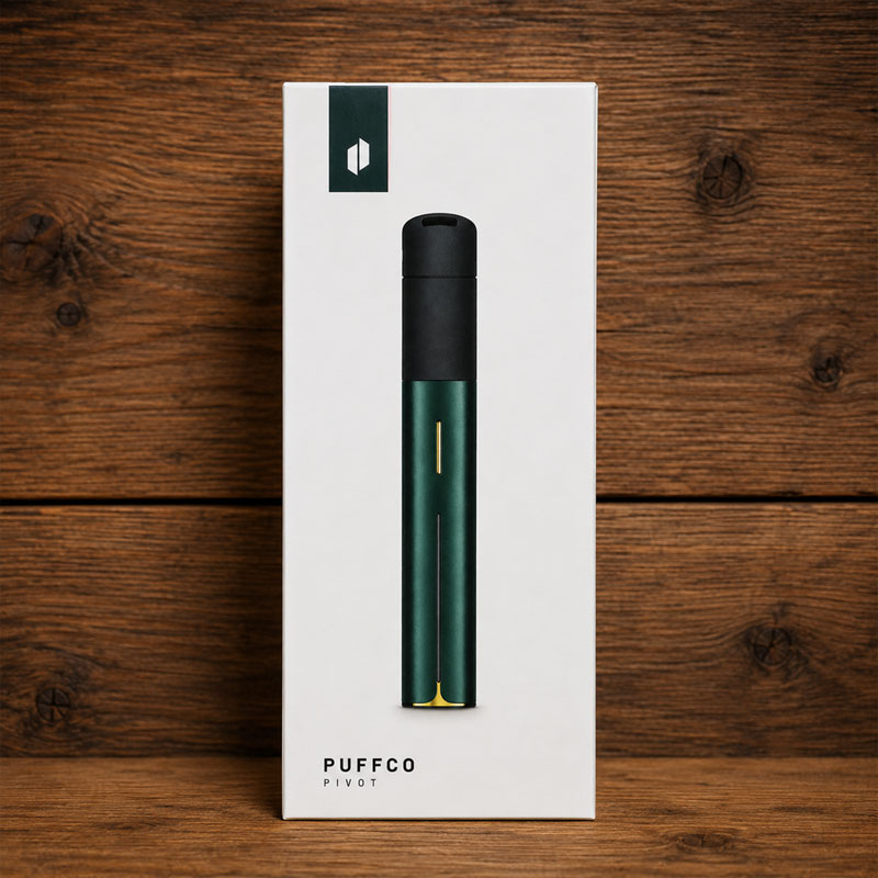 Puffco Pivot retail box standing upright on a dark pine wood background, showing the device packaging head-on with clean studio lighting.