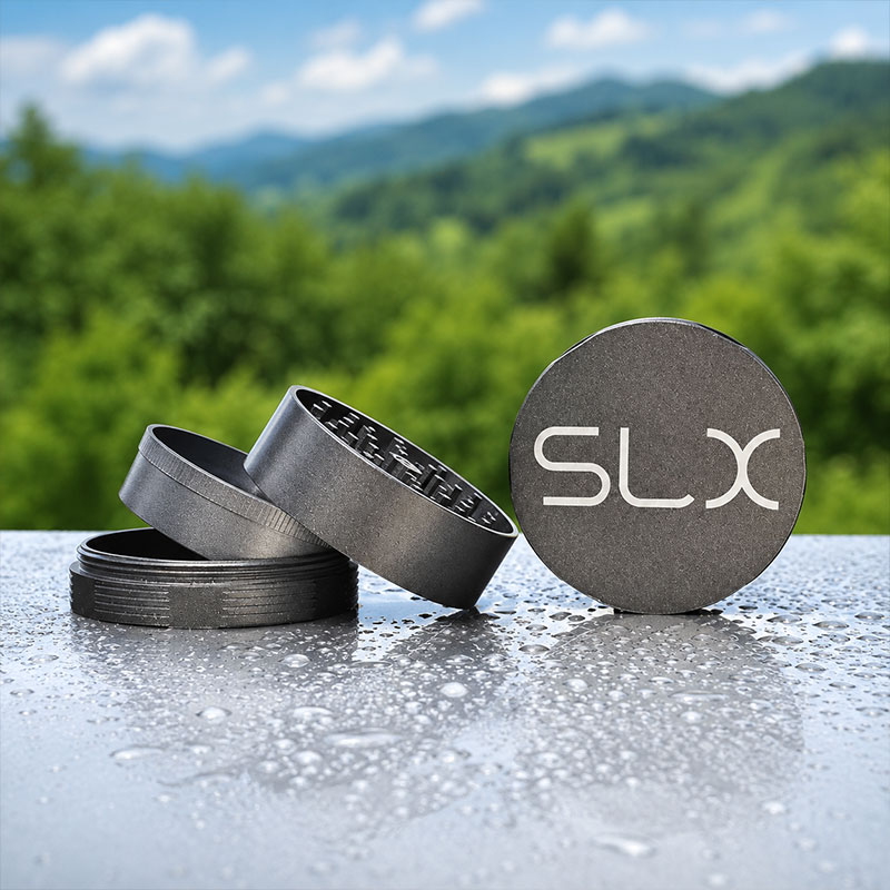 SLX grinder parts on a wet surface with a blurred green outdoor background