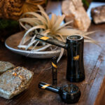 Marley Natural Smoked Taster displayed with matching black glass pipe and bubbler on a wooden table