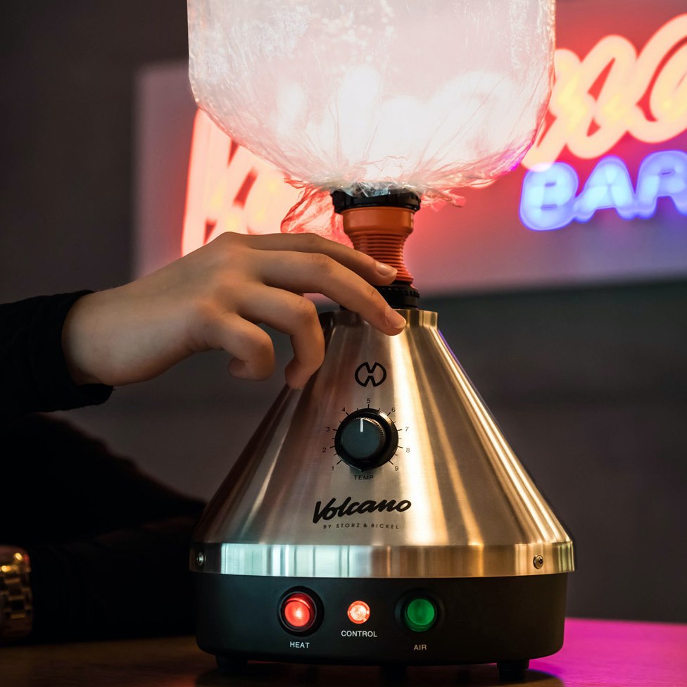 Volcano Classic vaporizer used at home with glowing controls