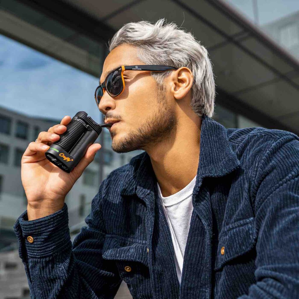 Storz & Bickel Crafty+ vaporizer used in a relaxed outdoor setting