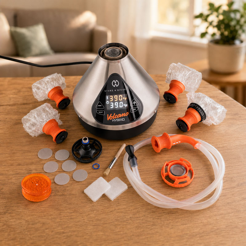 Storz & Bickel Volcano Hybrid desktop dry herb vaporizer with accessories on a wooden table in a cosy home setting.