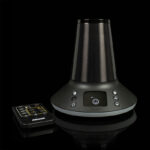 Arizer XQ2 desktop vaporizer with remote control on a black background