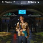 man travelling through train station with bag