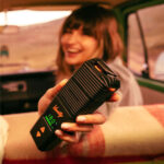 Woman holding a venty out of the window of her car