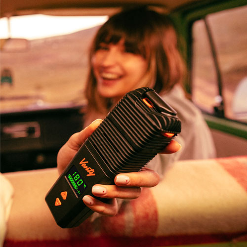 Woman holding a venty out of the window of her car