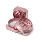 Rose gold Krush Kube 3.0 Grinder open with teeth visible