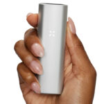 Person holding PAX Mini in Silver finish