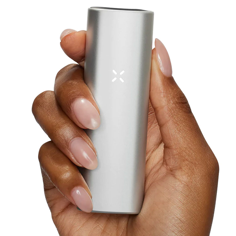 Person holding PAX Mini in Silver finish