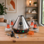 Volcano Classic vaporizer with accessories on a wooden table in a cosy home setting, shown in a square frame.