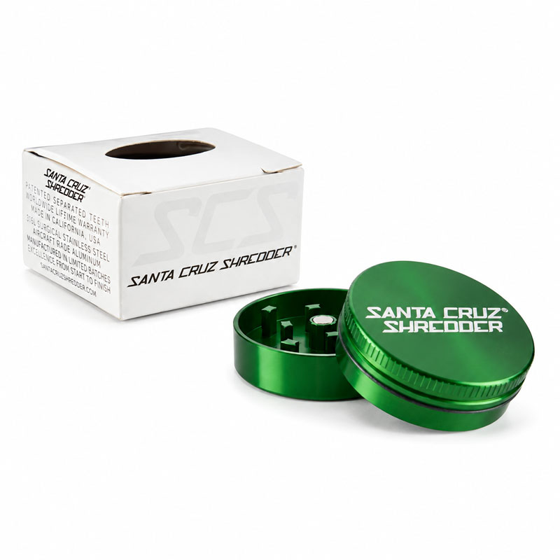 The box and the green grinder small with a white background