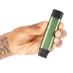 Hand holding green PAX Flow Stash Tube with compact smell-proof aluminium design