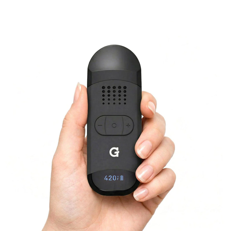 Hand holding the black G Pen Dash 2 vaporiser