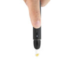 Close view of a hand pressing the Puffco Hot Knife 2.0 while concentrate sits on the tip