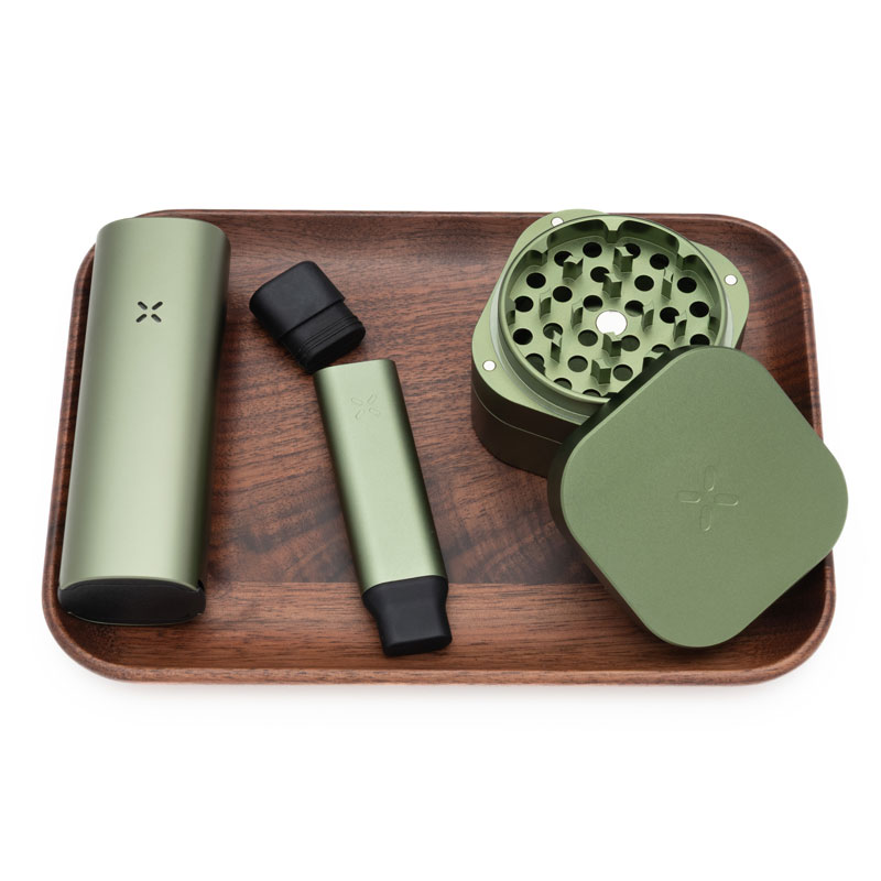 PAX 4 vaporizer, stash tube and grinder on wooden tray