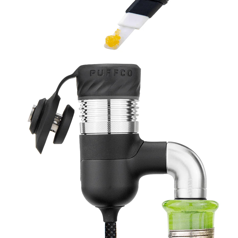 Puffco Peak Pro adapter with open chamber being loaded with concentrate