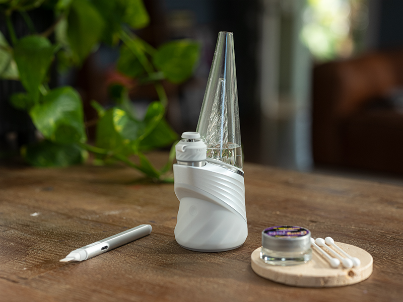 Puffco white peak pro on a wooden table