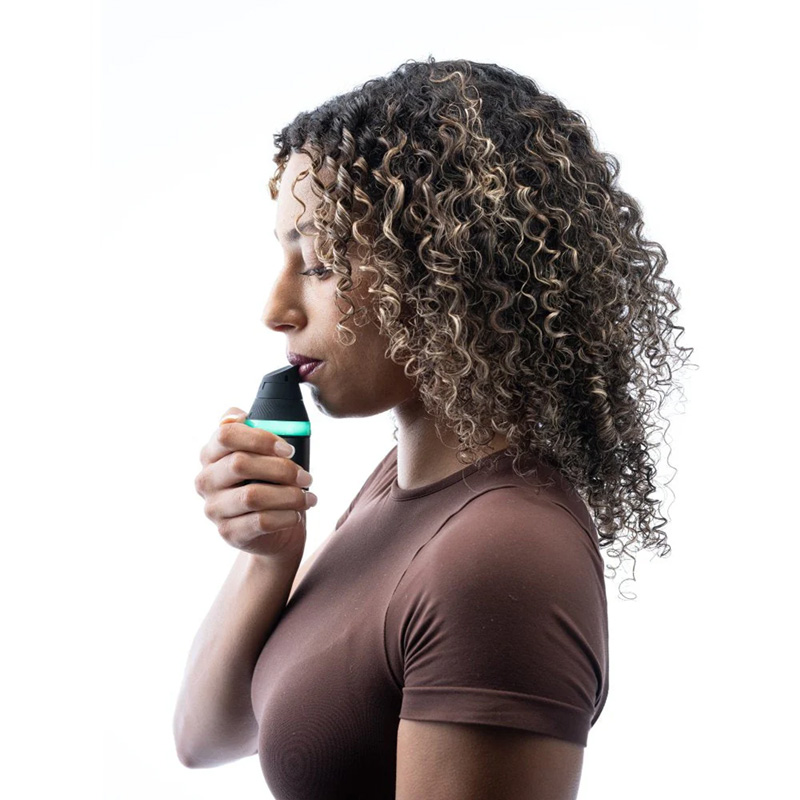 Person holding and using the Puffco Proxy Core Kit during a session