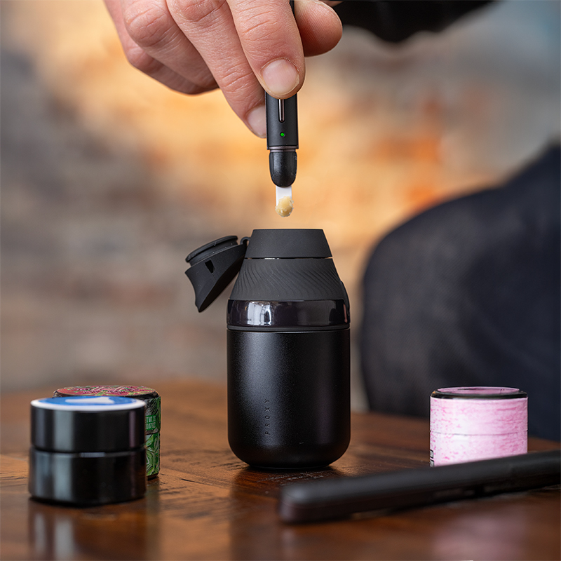 Close-up of a concentrate vaporizer chamber and dab tool