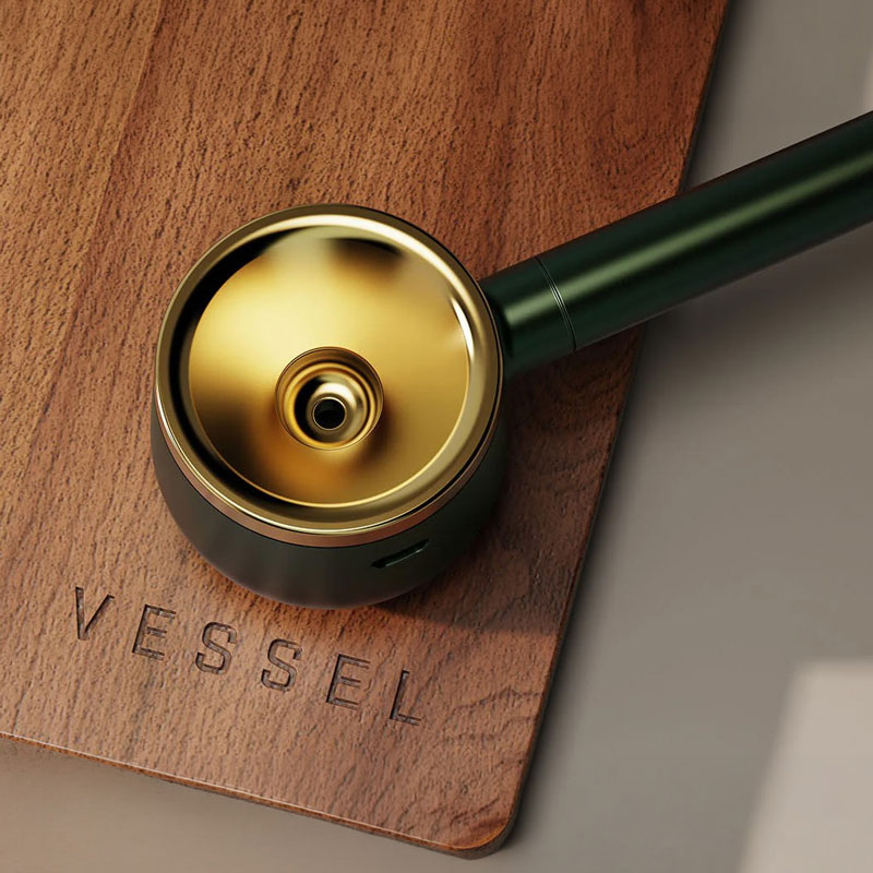 Vessel Evergreen smoking pipe resting on a walnut tray with engraved Vessel logo