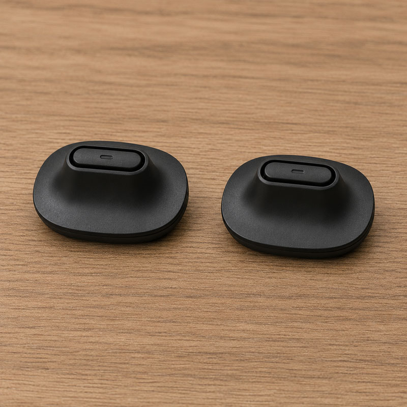 two raised black mouthpieces on a wooden background