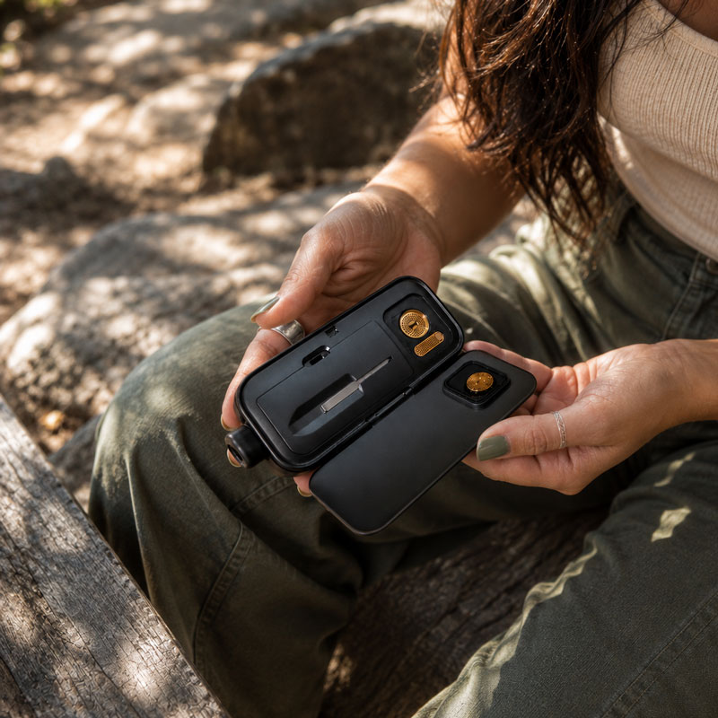 Woman holding the Pro 2 outdoors
