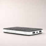 Apollo’s Curated fabric power bank with dual USB ports on a subtle light background
