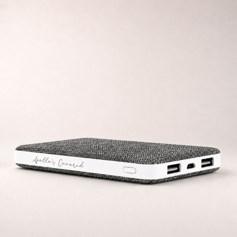 Apollo’s Curated fabric power bank with dual USB ports on a subtle light background