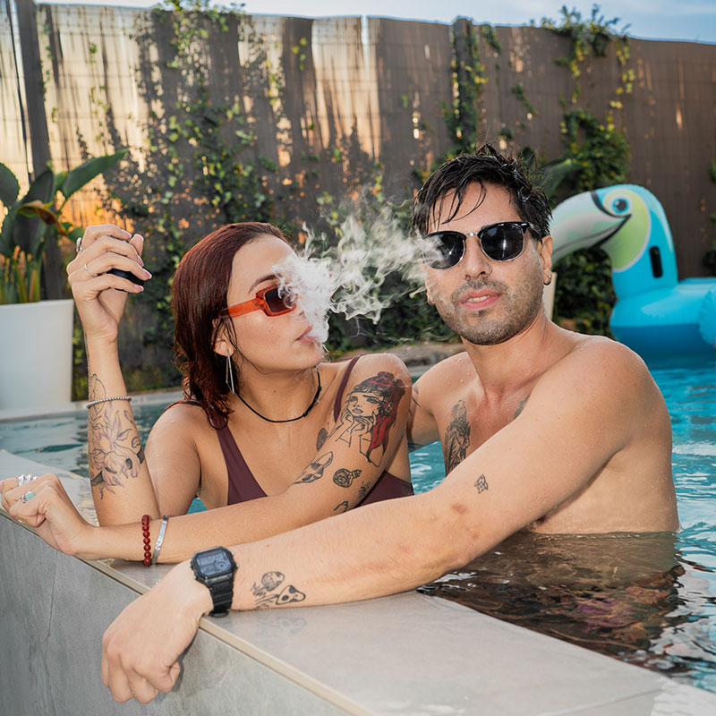 Couple using the Dr. Dabber Ghost 2 vaporizer in a swimming pool