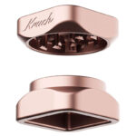 Rose gold Krush Kube 2.0 aluminium grinder opened to show its grinding teeth and two-part design