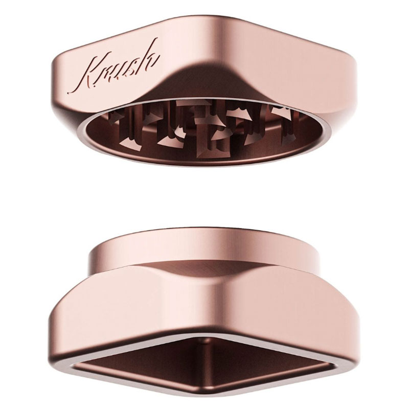 Rose gold Krush Kube 2.0 aluminium grinder opened to show its grinding teeth and two-part design