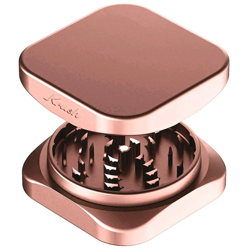 Rose gold Krush Kube 2.0 XL aluminium grinder opened to show its grinding teeth