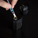 Concentrate being loaded into the Dr. Dabber Ghost 2 heating chamber