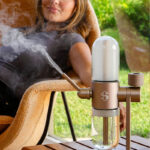 Woman using the Desert Rose Stündenglass Gravity Infuser outdoors