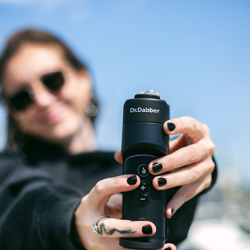 Dr. Dabber Switch GO being held outdoors to show its compact size