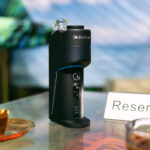 Dr. Dabber Switch GO upright on a tabletop with illuminated accent light